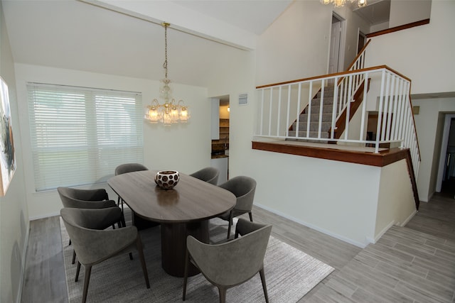 17647 Seven Pines Dr, Spring, TX 77379 - dining room with a chandelier, stairs, wood finished floors, vaulted ceiling, and baseboards