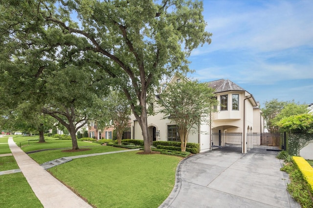 3423 Ella Lee Ln, Houston, TX 77027 - view of front facade with a gate, stucco siding, and driveway