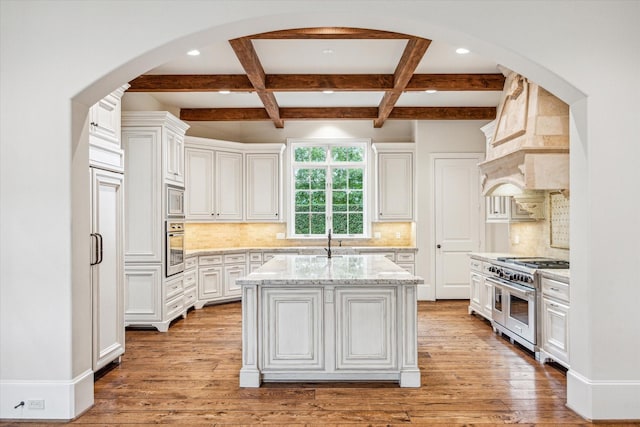 3423 Ella Lee Ln, Houston, TX 77027 - kitchen with stainless steel appliances, recessed lighting, arched walkways, beam ceiling, and coffered ceiling