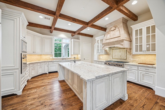 3423 Ella Lee Ln, Houston, TX 77027 - kitchen featuring stainless steel appliances, custom exhaust hood, dark wood-type flooring, coffered ceiling, and beam ceiling