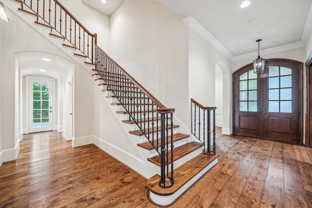 3423 Ella Lee Ln, Houston, TX 77027 - entrance foyer featuring arched walkways, hardwood / wood-style floors, french doors, stairway, and crown molding