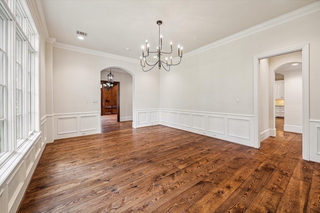3423 Ella Lee Ln, Houston, TX 77027 - spare room featuring arched walkways, a chandelier, ornamental molding, dark wood finished floors, and a decorative wall