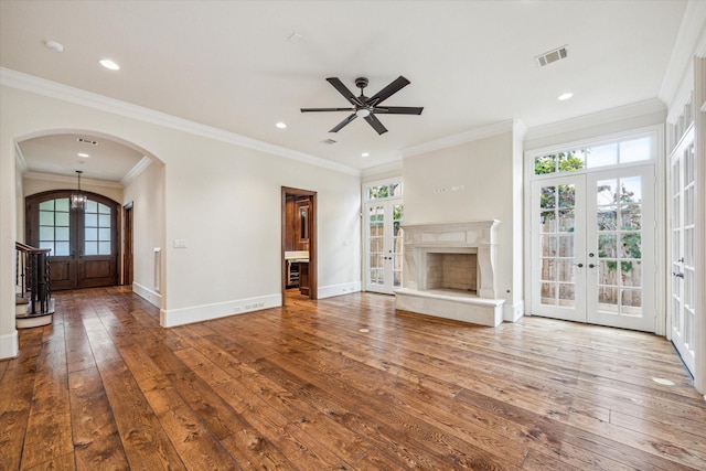 3423 Ella Lee Ln, Houston, TX 77027 - unfurnished living room featuring french doors, arched walkways, wood-type flooring, baseboards, and recessed lighting