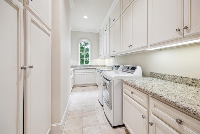 3423 Ella Lee Ln, Houston, TX 77027 - laundry area featuring cabinet space, washing machine and dryer, ornamental molding, light tile patterned flooring, and recessed lighting