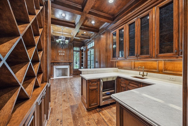 3423 Ella Lee Ln, Houston, TX 77027 - kitchen featuring wood ceiling with exposed beams, beverage cooler, hardwood / wood-style floors, light countertops, and a sink
