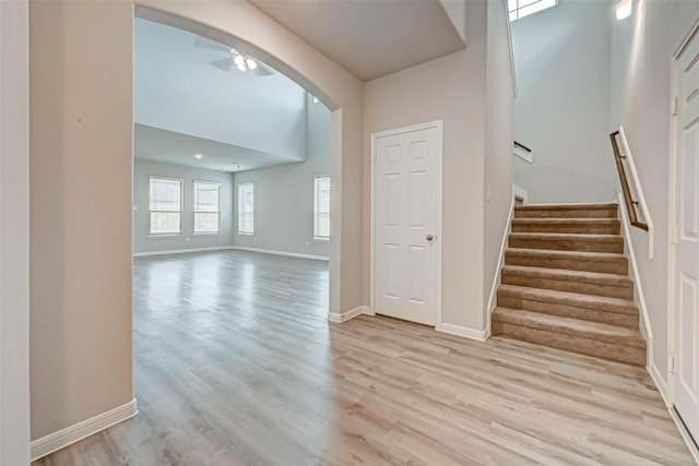 5819 Grantgrala Dr, Katy, TX 77493 - stairway with arched walkways, wood finished floors, baseboards, and a towering ceiling