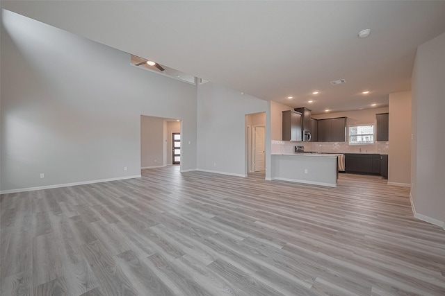 5819 Grantgrala Dr, Katy, TX 77493 - unfurnished living room featuring light wood-style flooring, baseboards, and recessed lighting