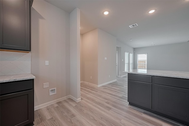 5819 Grantgrala Dr, Katy, TX 77493 - kitchen featuring light wood-style flooring, baseboards, decorative backsplash, recessed lighting, and light stone counters