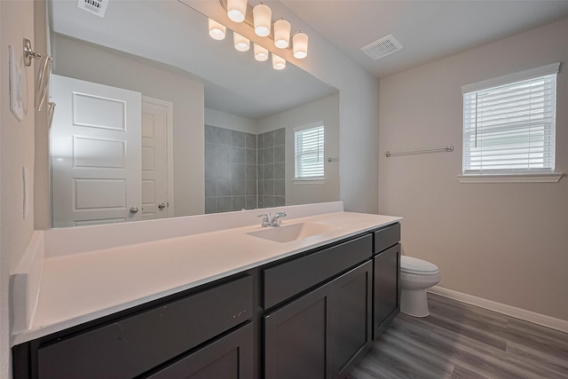 5819 Grantgrala Dr, Katy, TX 77493 - full bath with baseboards, toilet, vanity, wood finished floors, and tiled shower