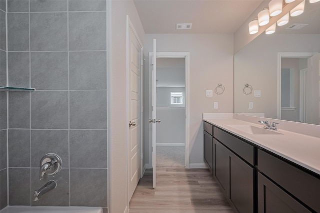5819 Grantgrala Dr, Katy, TX 77493 - bathroom with wood finished floors, vanity, shower / bath combination, and baseboards