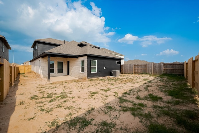 5819 Grantgrala Dr, Katy, TX 77493 - back of property with brick siding, a fenced backyard, roof with shingles, a patio, and central AC unit