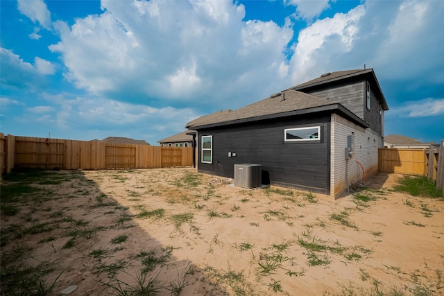 5819 Grantgrala Dr, Katy, TX 77493 - back of house with cooling unit, a fenced backyard, and roof with shingles
