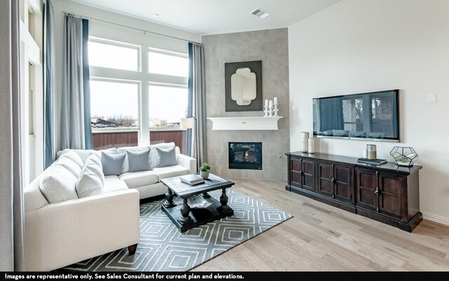 23145 Chablis Dr, Alvin, TX 77511 - living room with wood finished floors and a tiled fireplace