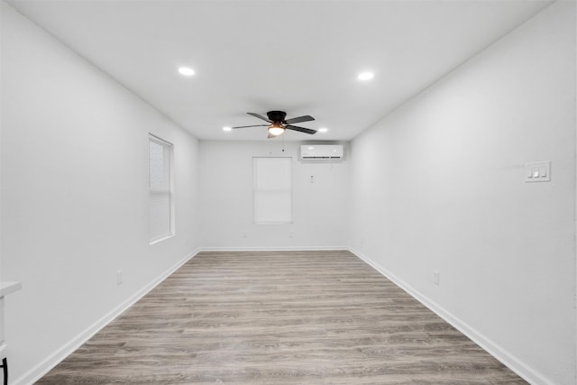 4002 Rutland St, Houston, TX 77018 - spare room with a ceiling fan, recessed lighting, a wall unit AC, light wood finished floors, and baseboards