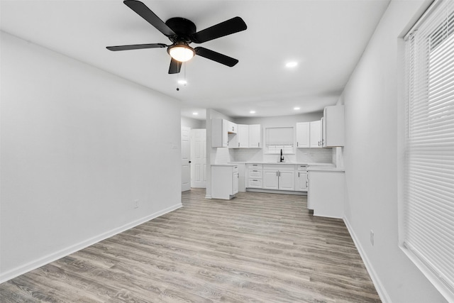 4002 Rutland St, Houston, TX 77018 - kitchen featuring a sink, baseboards, white cabinets, light wood finished floors, and recessed lighting