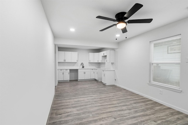 4002 Rutland St, Houston, TX 77018 - kitchen with white cabinets, ceiling fan, light wood-style floors, baseboards, and recessed lighting