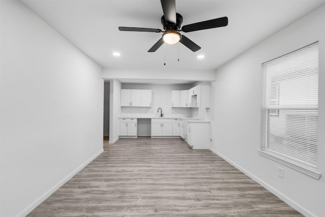 4002 Rutland St, Houston, TX 77018 - kitchen with a sink, light countertops, white cabinets, baseboards, and recessed lighting