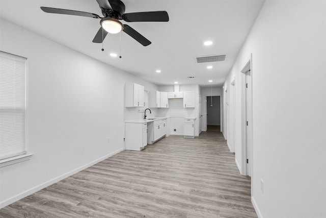 4002 Rutland St, Houston, TX 77018 - kitchen featuring a sink, light wood finished floors, dishwasher, white cabinets, and recessed lighting