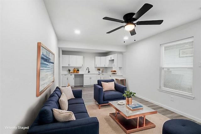 4002 Rutland St, Houston, TX 77018 - living room with light wood finished floors, a ceiling fan, and baseboards
