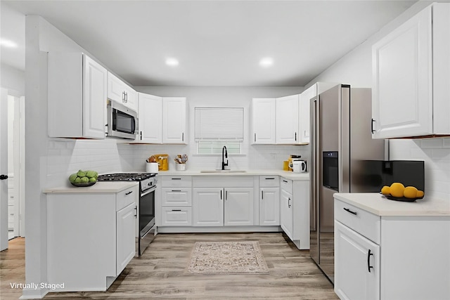 4002 Rutland St, Houston, TX 77018 - kitchen with stainless steel appliances, a sink, light wood-style flooring, and recessed lighting