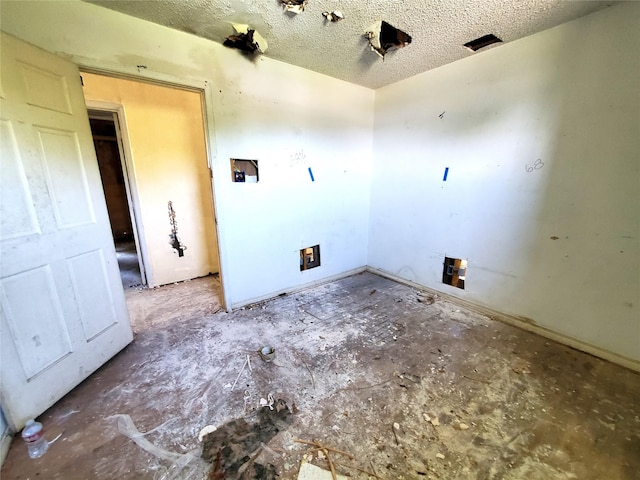 1101 4th Ave N, Texas City, TX 77590 - unfurnished room with a textured ceiling and baseboards