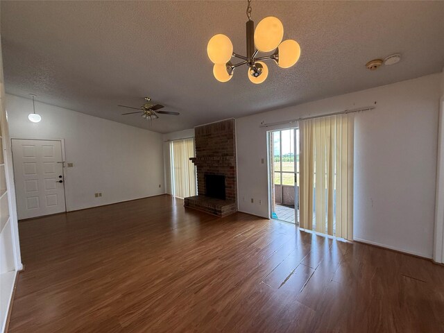 10555 Turtlewood Ct Unit 2011, Houston, TX 77072 - unfurnished living room with a textured ceiling, wood finished floors, a fireplace, a chandelier, and ceiling fan