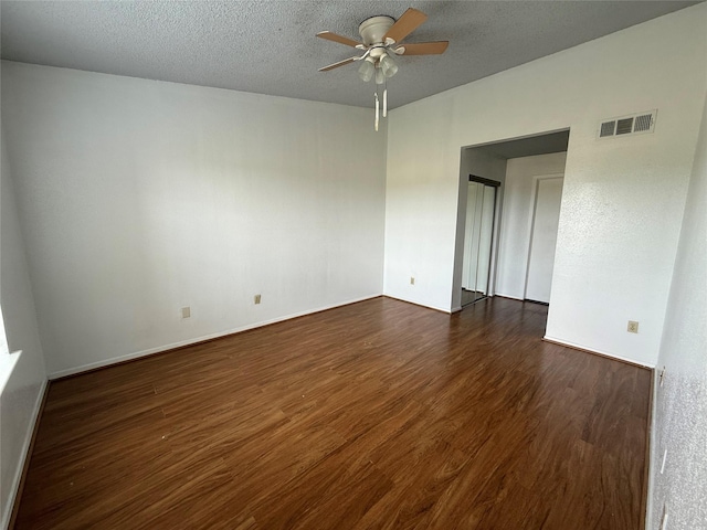 10555 Turtlewood Ct Unit 2011, Houston, TX 77072 - spare room with a ceiling fan, dark wood-style floors, a textured ceiling, and baseboards