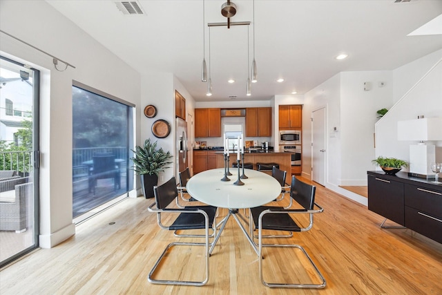 4502 Maxie St Unit A, Houston, TX 77007 - dining room with baseboards, light wood-type flooring, healthy amount of natural light, and recessed lighting
