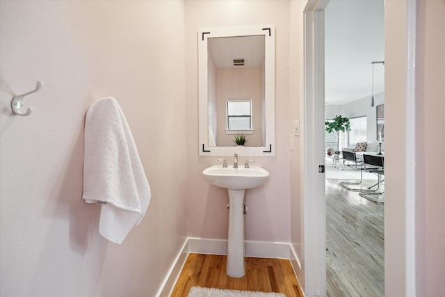 4502 Maxie St Unit A, Houston, TX 77007 - bathroom featuring wood finished floors, baseboards, and healthy amount of natural light