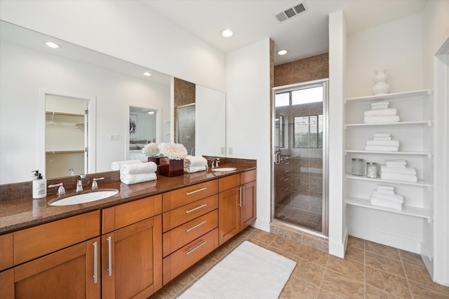 4502 Maxie St Unit A, Houston, TX 77007 - bathroom with double vanity, a stall shower, a spacious closet, recessed lighting, and tile patterned floors