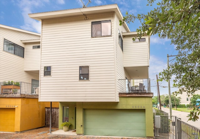 4502 Maxie St Unit A, Houston, TX 77007 - back of house with a balcony and a garage
