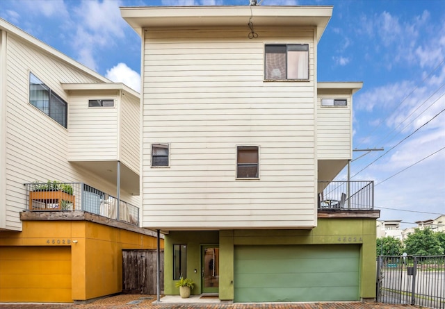 4502 Maxie St Unit A, Houston, TX 77007 - rear view of house with a balcony, an attached garage, and decorative driveway