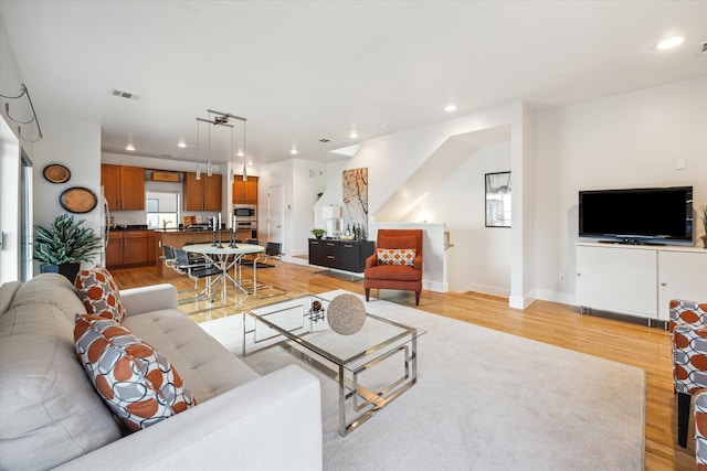 4502 Maxie St Unit A, Houston, TX 77007 - living room with light wood finished floors, plenty of natural light, recessed lighting, and baseboards