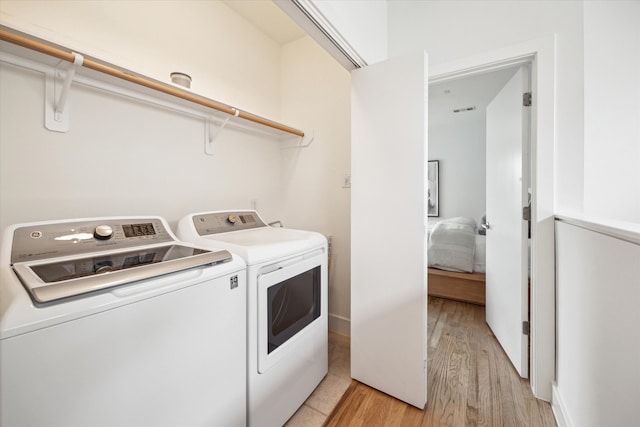 4502 Maxie St Unit A, Houston, TX 77007 - laundry room featuring independent washer and dryer and light wood-style floors