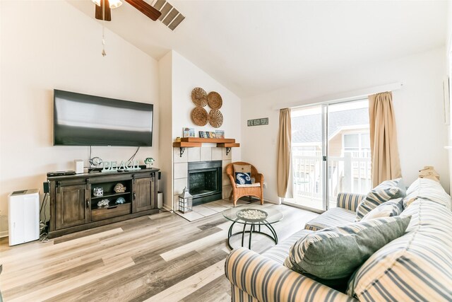 3506 Cove View Blvd Unit 506, Galveston, TX 77554 - living area featuring a fireplace, a ceiling fan, light wood finished floors, and high vaulted ceiling