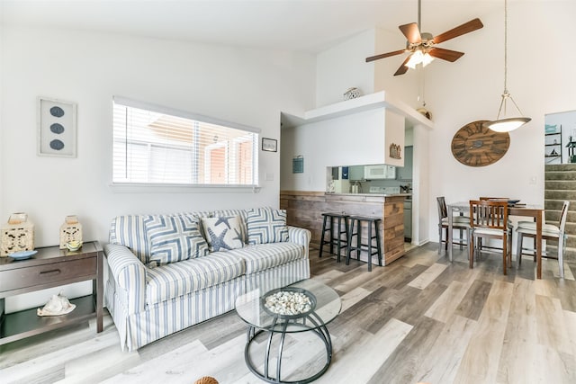 3506 Cove View Blvd Unit 506, Galveston, TX 77554 - living room featuring a ceiling fan, high vaulted ceiling, wood finished floors, and stairway