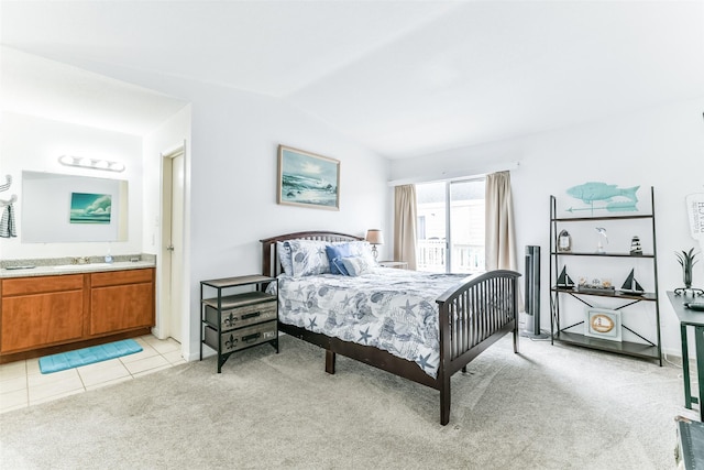 3506 Cove View Blvd Unit 506, Galveston, TX 77554 - bedroom with lofted ceiling, light colored carpet, a sink, connected bathroom, and light tile patterned floors