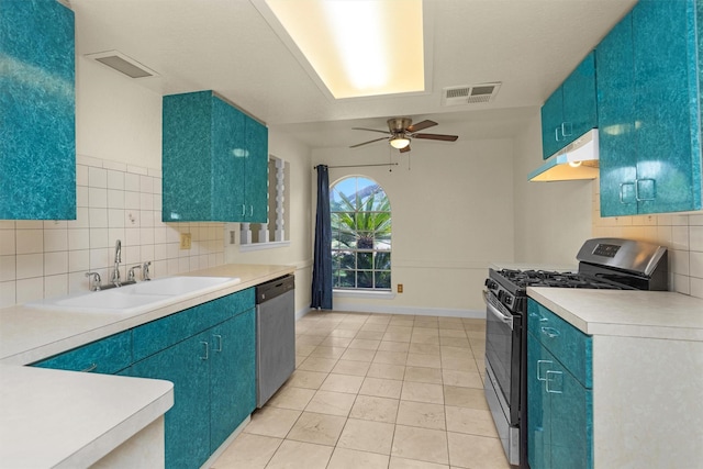 7322 Sawmill Trl, Houston, TX 77040 - kitchen featuring under cabinet range hood, appliances with stainless steel finishes, a sink, and blue cabinetry