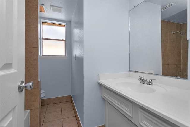 7322 Sawmill Trl, Houston, TX 77040 - full bathroom with toilet, vanity, tile patterned flooring, and baseboards