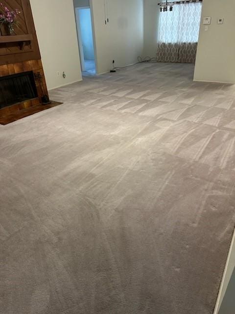 11207 Windmark Pl, Houston, TX 77099 - unfurnished living room featuring light colored carpet and a fireplace