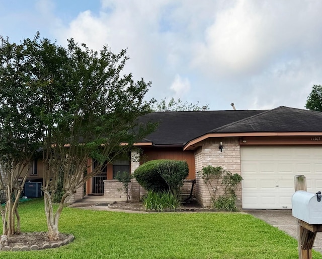 11207 Windmark Pl, Houston, TX 77099 - view of front facade with brick siding, a front lawn, central air condition unit, an attached garage, and roof with shingles