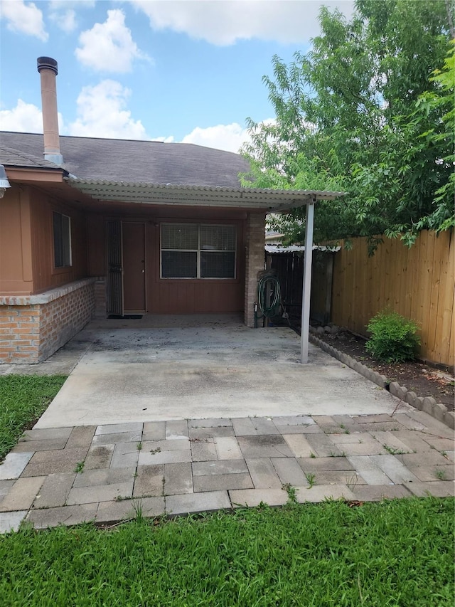 11207 Windmark Pl, Houston, TX 77099 - back of house with an attached carport, a patio area, and brick siding