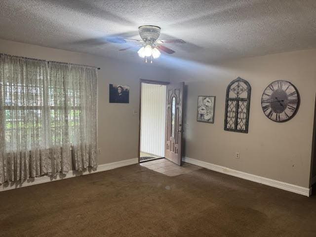 3475 Pelican St, Pinehurst, TX 77630 - spare room featuring baseboards, a textured ceiling, a ceiling fan, and carpet floors