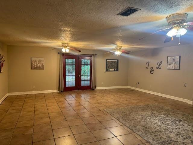 3475 Pelican St, Pinehurst, TX 77630 - empty room featuring ceiling fan, french doors, tile patterned flooring, a textured ceiling, and baseboards