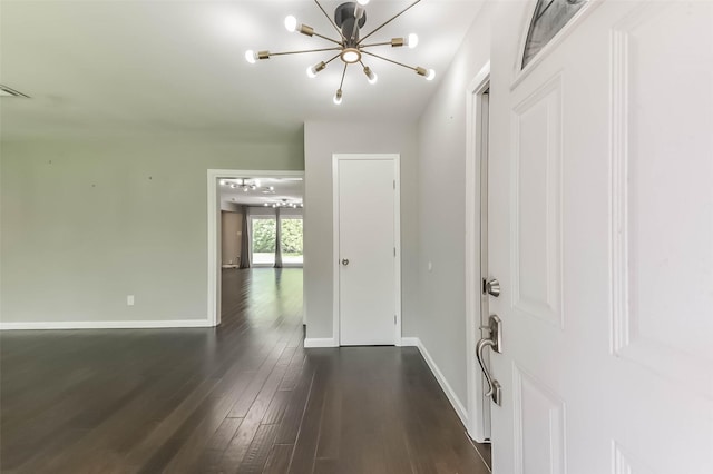 9207 Timberside Dr, Houston, TX 77025 - foyer entrance with a chandelier, dark wood-style flooring, and baseboards