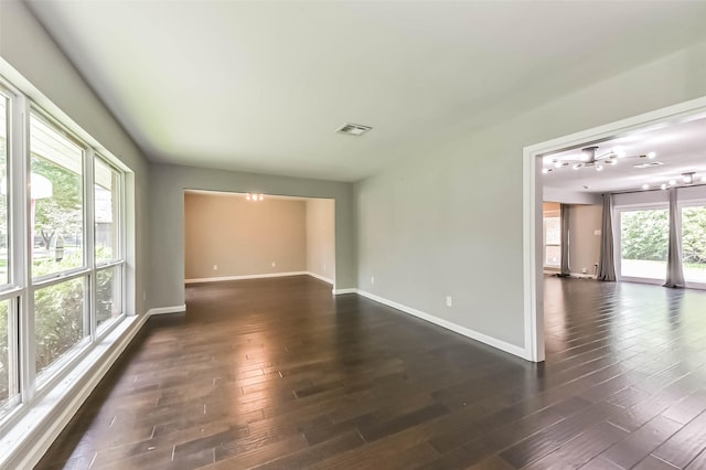 9207 Timberside Dr, Houston, TX 77025 - unfurnished room with dark wood finished floors, baseboards, and a chandelier