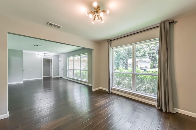 9207 Timberside Dr, Houston, TX 77025 - empty room featuring dark wood-type flooring, baseboards, and plenty of natural light
