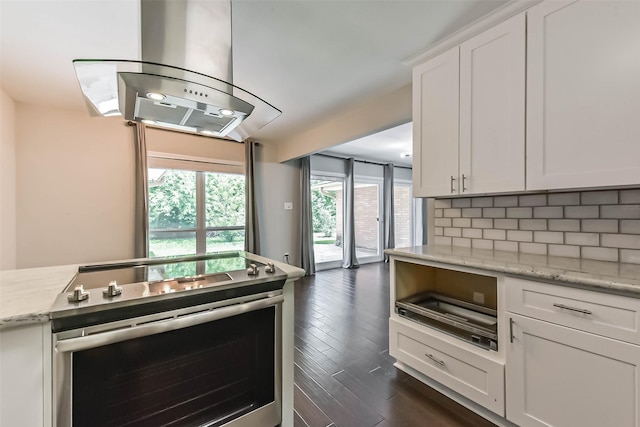 9207 Timberside Dr, Houston, TX 77025 - kitchen with stainless steel range with electric cooktop, island range hood, dark wood-style flooring, tasteful backsplash, and white cabinetry
