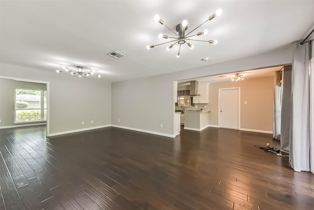 9207 Timberside Dr, Houston, TX 77025 - unfurnished living room with a chandelier, dark wood-style floors, and baseboards