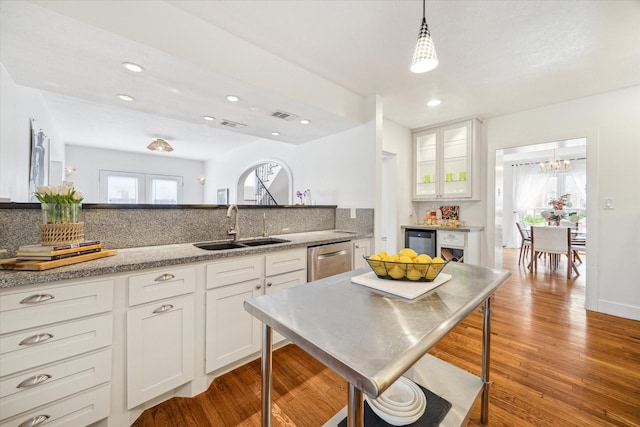 2108 Branard St, Houston, TX 77098 - kitchen featuring a sink, stainless steel dishwasher, white cabinets, decorative backsplash, and recessed lighting